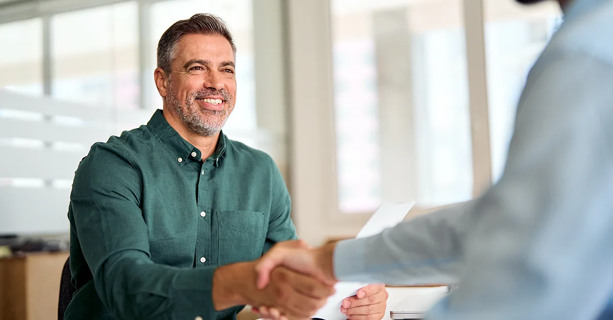 Two people shaking hands during a business meeting