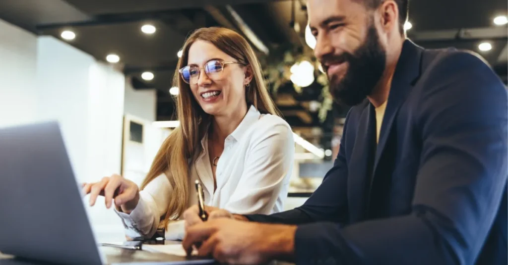 A man and woman reading the Labour government employee law changes on the Brightmine HR & Compliance Centre