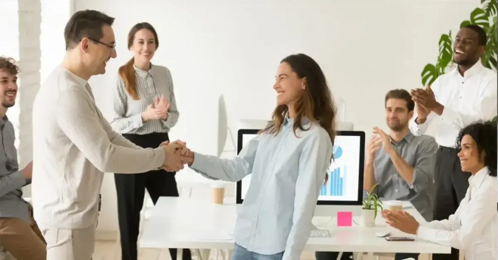 Engaged employees celebrating in the office together.