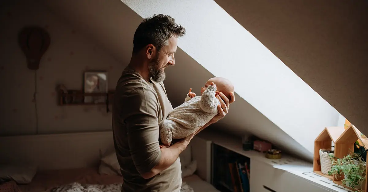 Father with their child getitng ready to go on paternity leave in the UK.