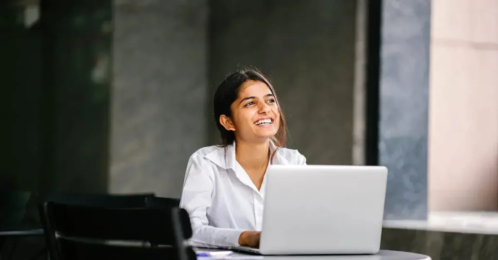 Employee on her laptop learning about her employee benefits.
