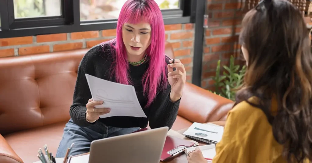 Non-binary employee reviewing their rights to be protected from discrimination at work.