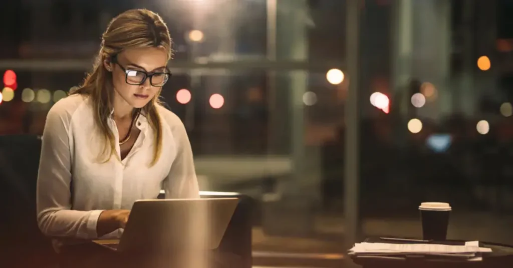 HR leader reviewing the general election 2024 party policies on her laptop.