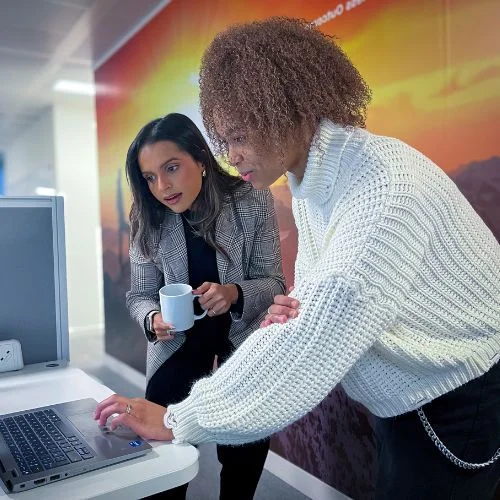 Employees reading the latest HR insights on Brightmine HR & Compliance Centre