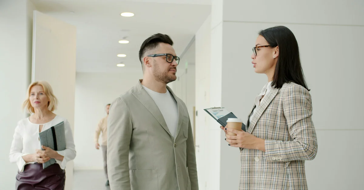 Employees discussing the employee wellbeing gap in their workplace.