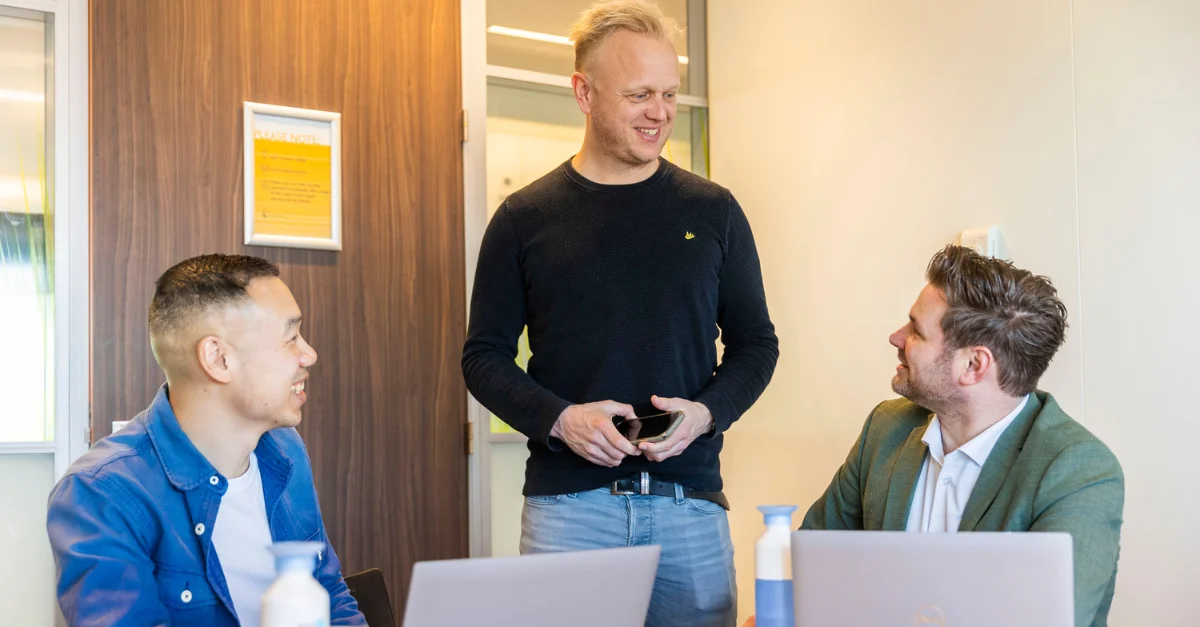 Employees discussing men's health at work.