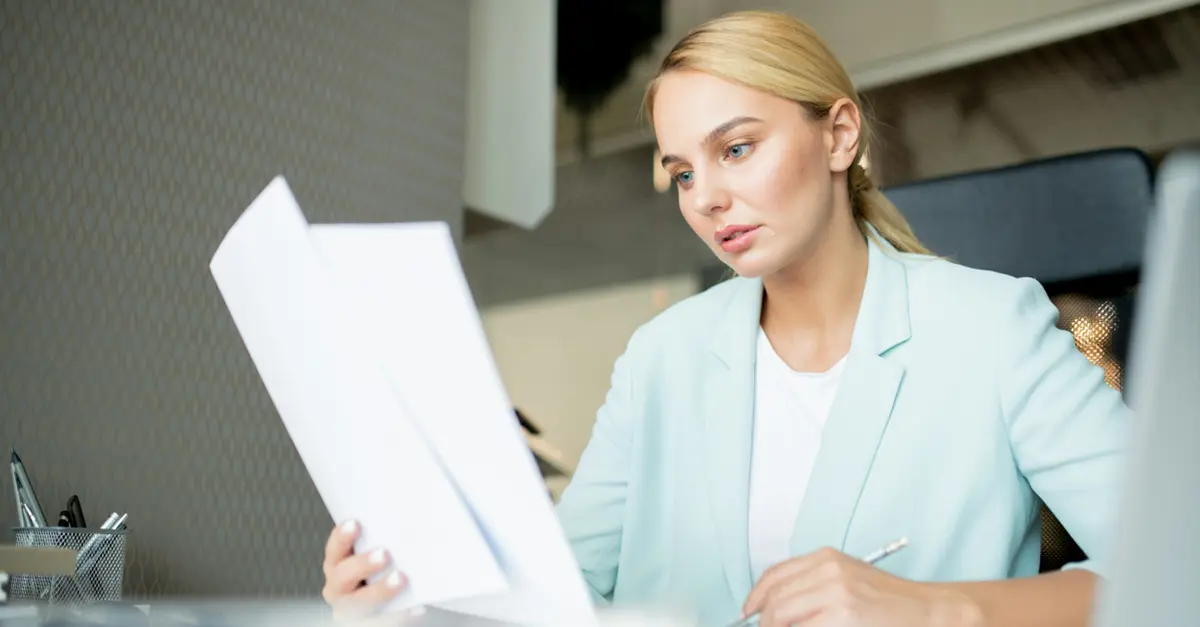 person-reviewing-documents-at-office-desk
