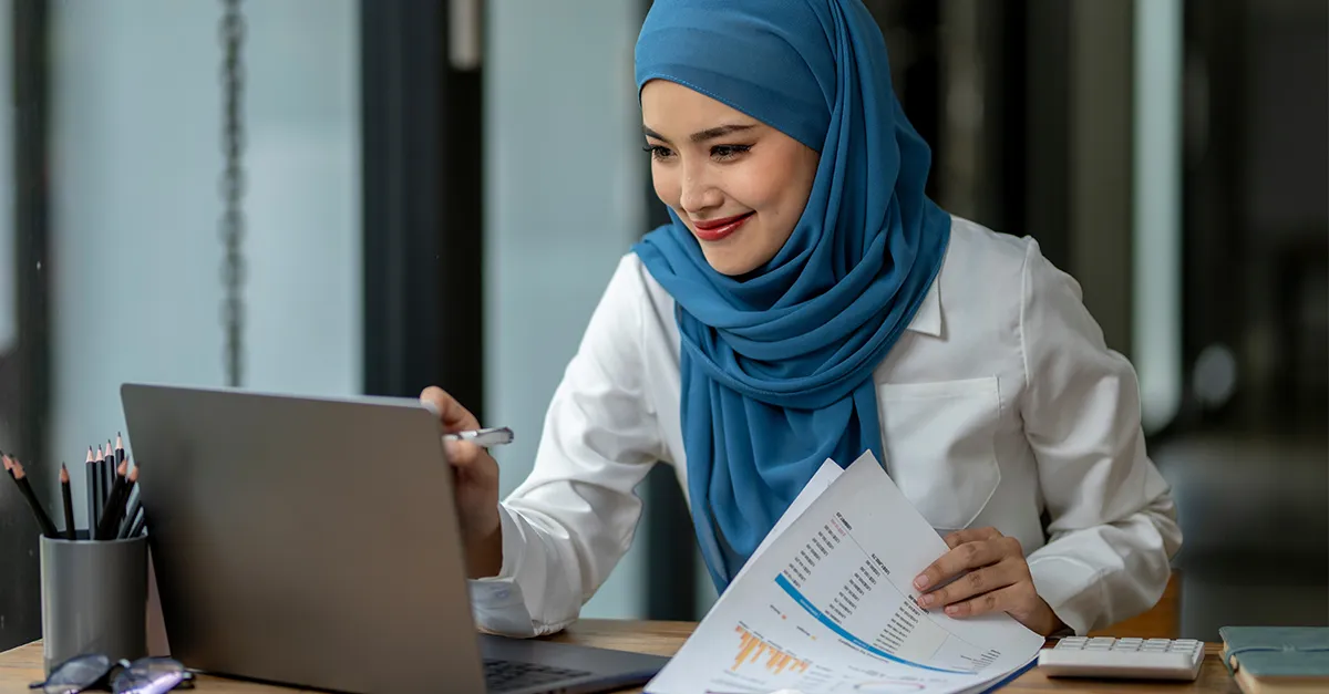 person-analyzing-business-reports-while-working-on-laptop