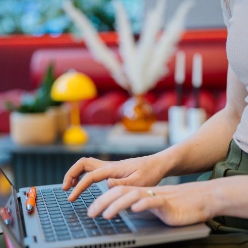 young woman using laptop to update her school's HR policies