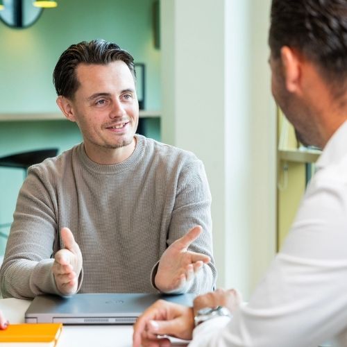 Two male colleagues discussing the impact of employment law changes on their school policies