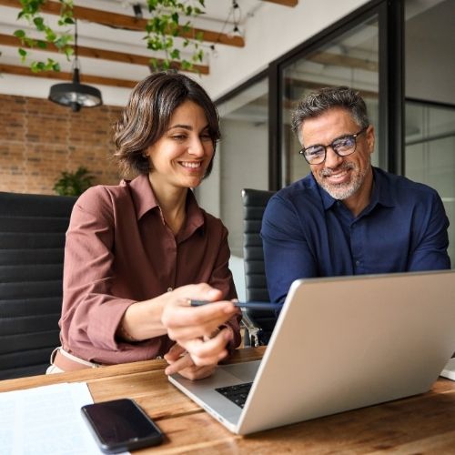 HR professional and headteacher reviewing changes to school employment policies