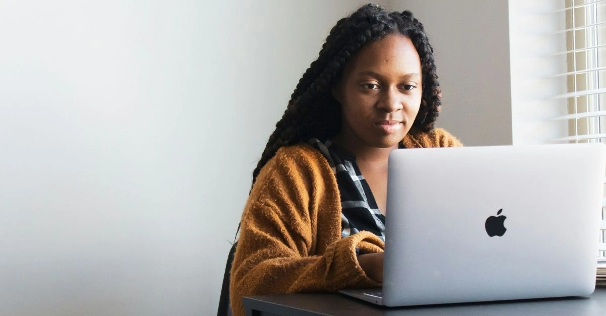 HR professional reviewing pay trends on a laptop