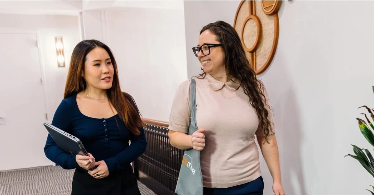 Two female HR colleagues talking and walking