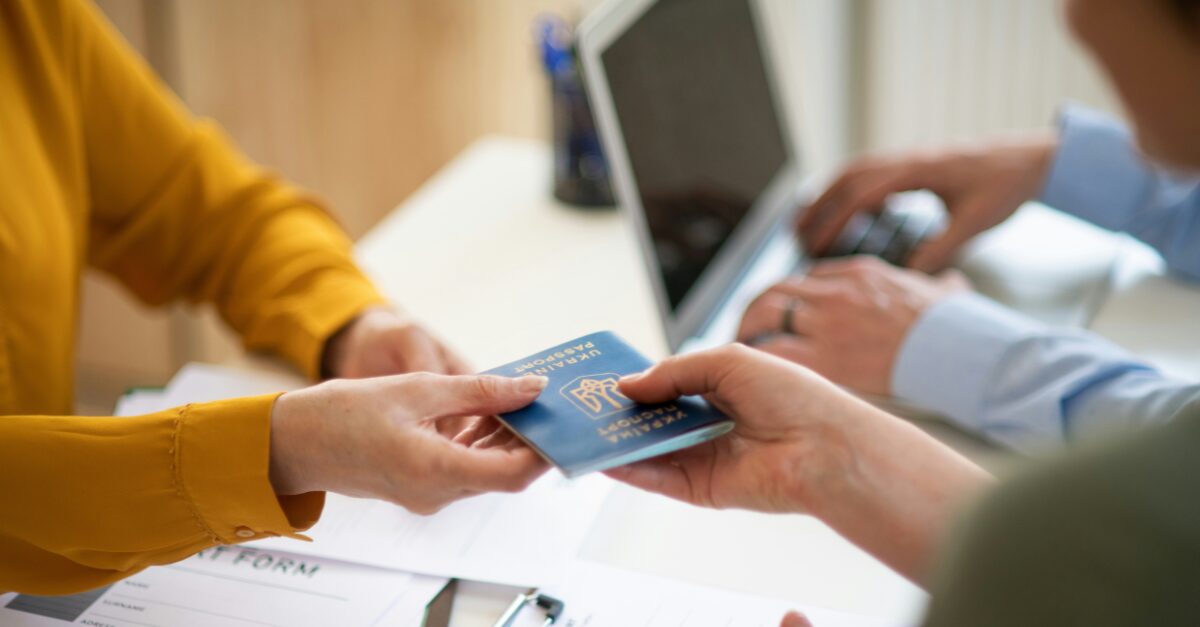 New Trump gold card holder handing their passport over to immigration.