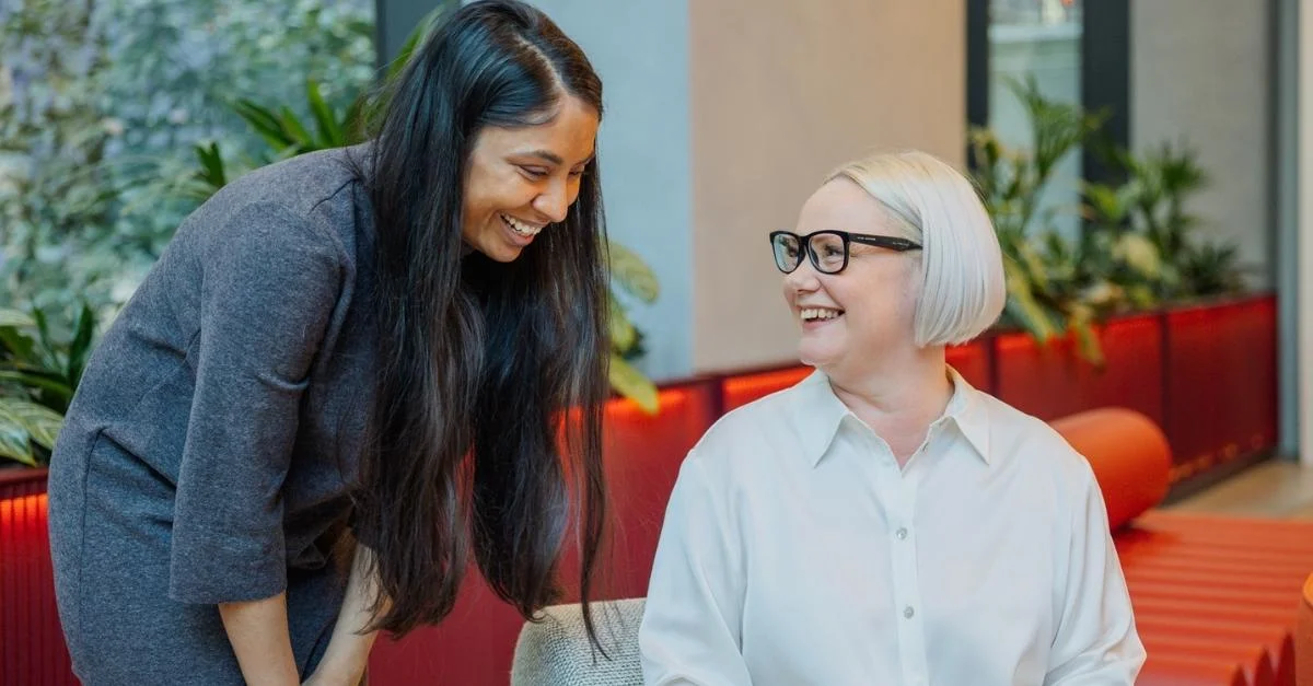 Two female HR professionals discussing ADA and FMLA