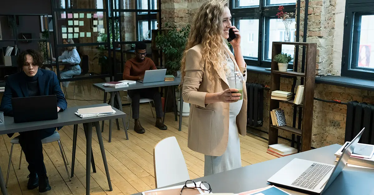 Female office worker holding mobile phone
