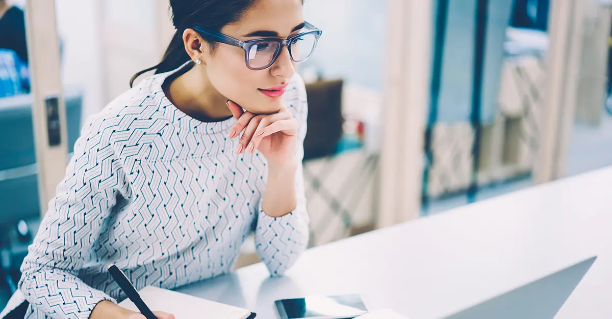 Female office worker working taking notes