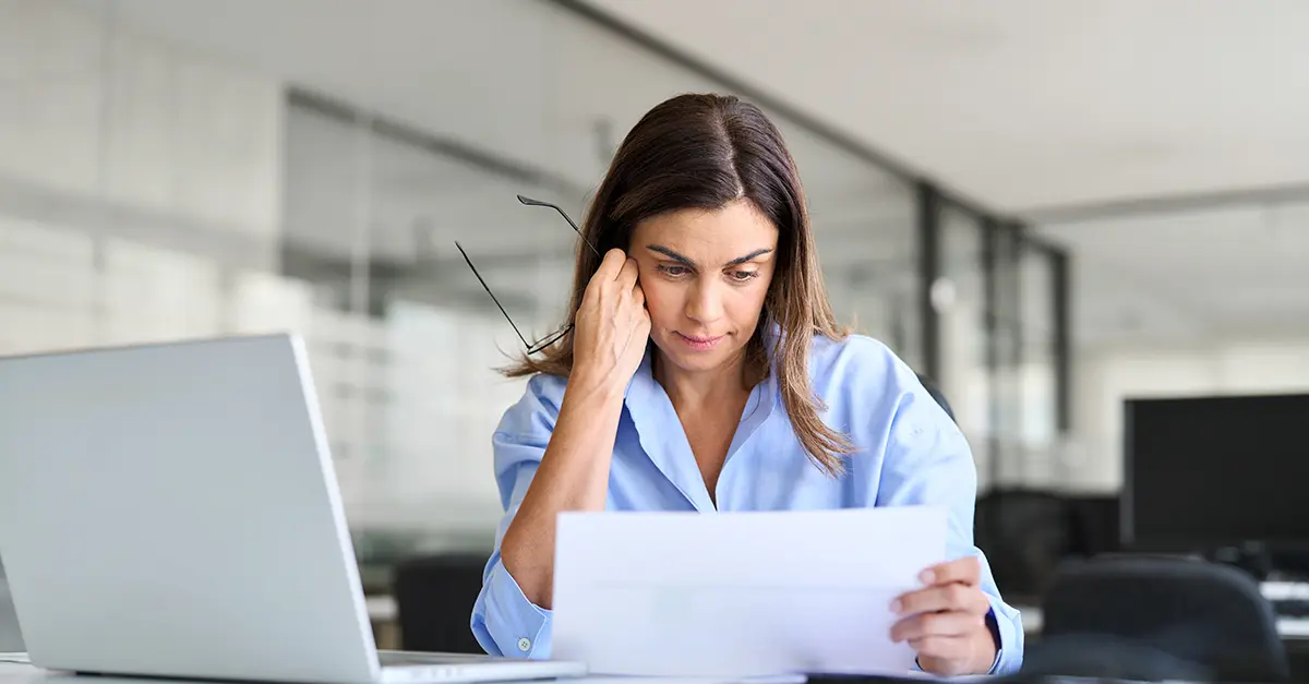 Brightmine-Female office worker reviewing her notes