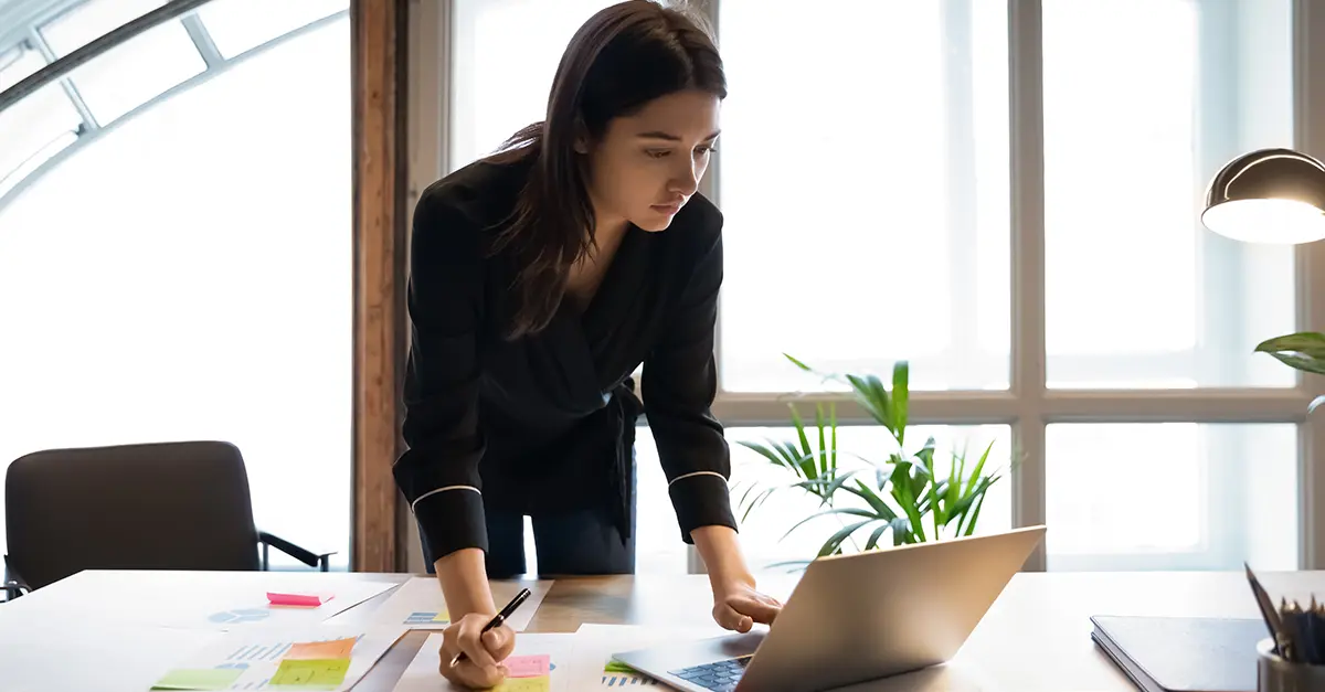 Brightmine office worker working on her laptop