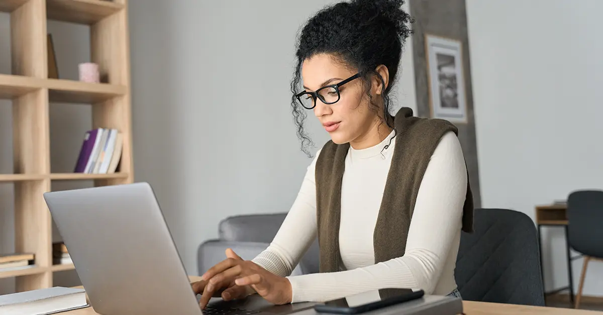 Brightmine office worker working on her laptop