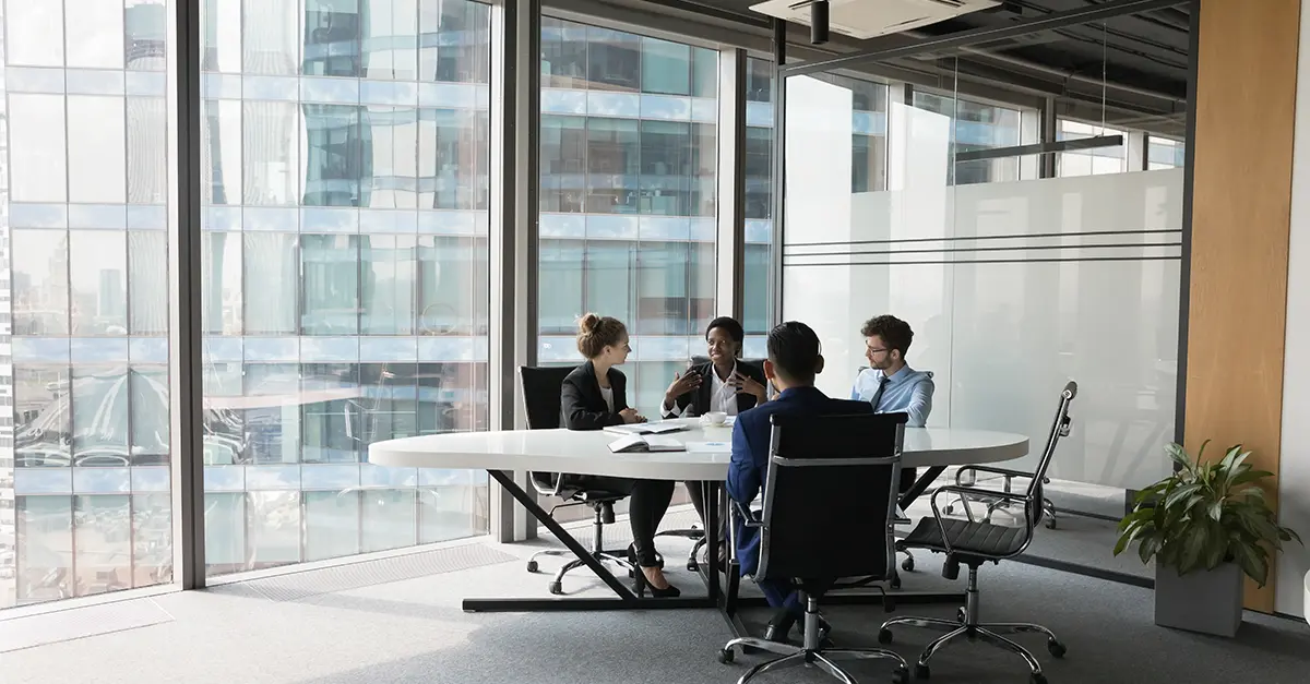 Young employee in small group meeting